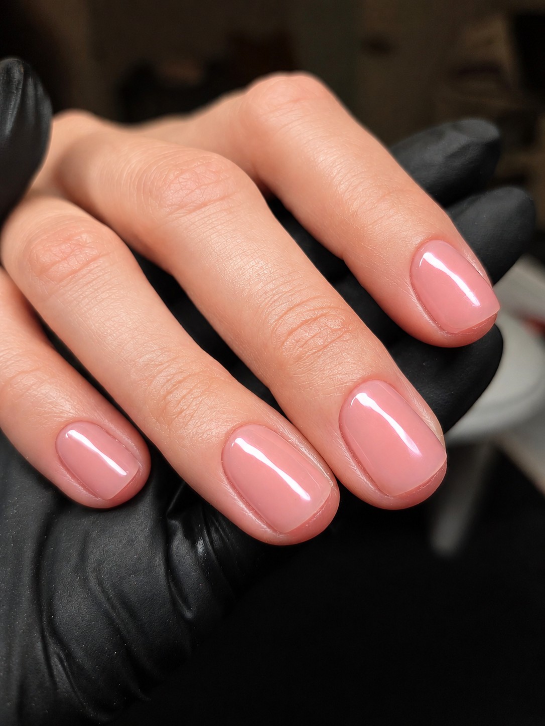 Close detail of precise pink gel overlay manicure